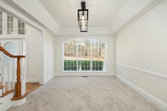 unfurnished dining area featuring light colored carpet