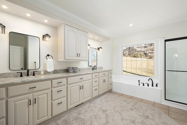 interior space featuring tile patterned floors, crown molding, vanity, and separate shower and tub