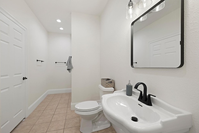 bathroom with tile patterned floors, sink, and toilet