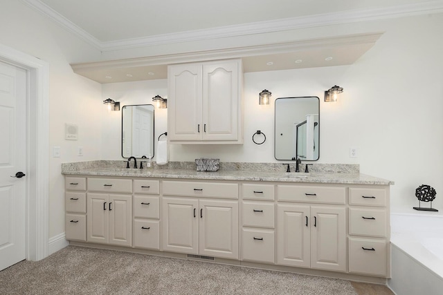 bathroom with vanity, a tub, and ornamental molding