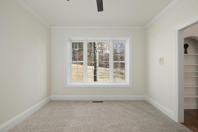 interior space featuring crown molding, carpet floors, and ceiling fan