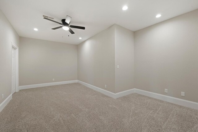 unfurnished room featuring ceiling fan and carpet