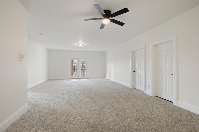 empty room with ceiling fan, light colored carpet, and french doors