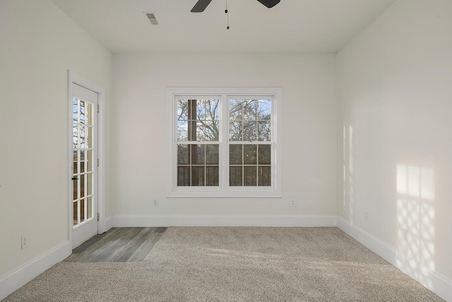 spare room with light carpet and ceiling fan