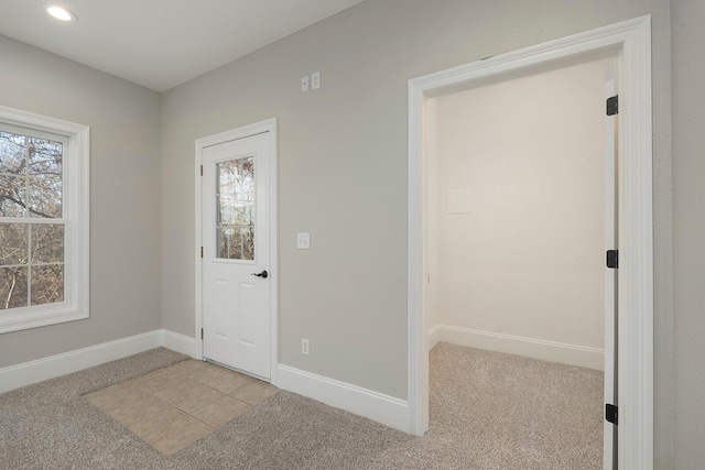 entryway featuring light colored carpet and a healthy amount of sunlight