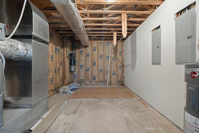 basement featuring electric panel, heating unit, and water heater