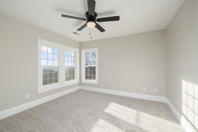 spare room featuring ceiling fan and carpet