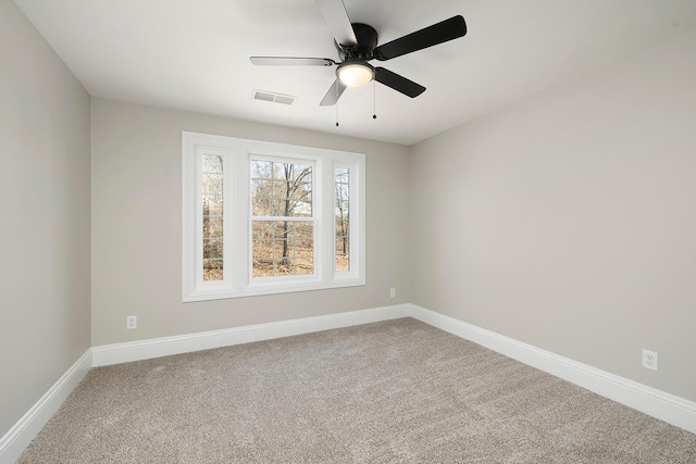 carpeted empty room featuring ceiling fan