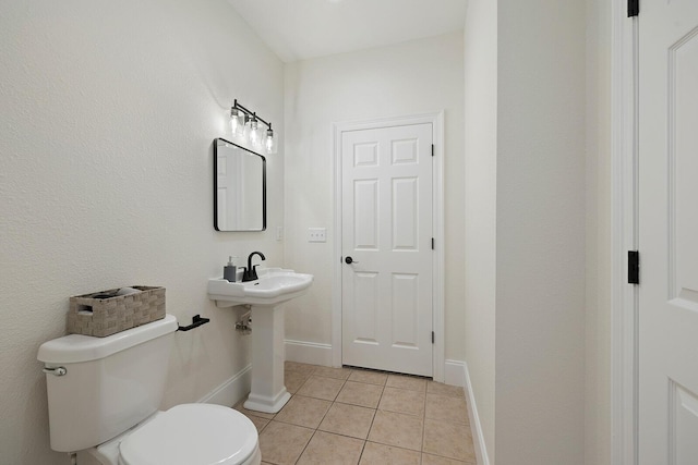 bathroom featuring tile patterned flooring and toilet