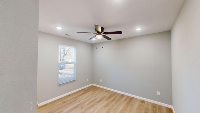 spare room featuring ceiling fan and light wood-type flooring