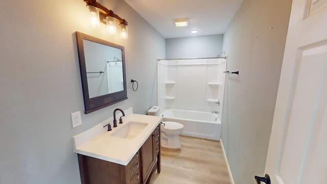 full bathroom with hardwood / wood-style flooring, vanity, toilet, and washtub / shower combination