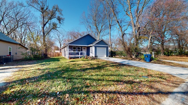 view of front facade featuring covered porch, central AC, a front lawn, and a garage