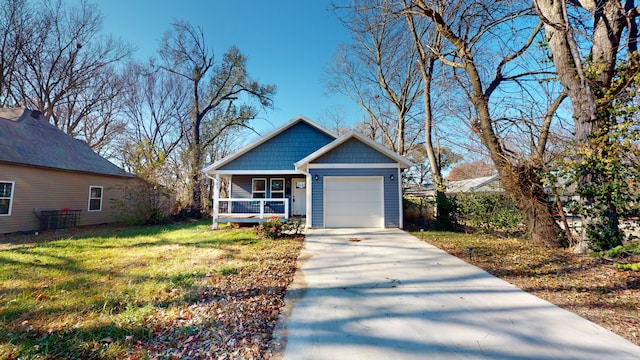 view of front of house featuring a porch, a garage, and a front lawn