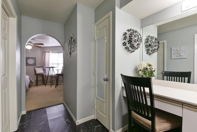 dining area featuring dark colored carpet and ceiling fan