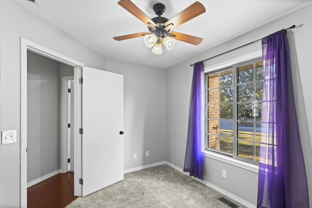 spare room featuring carpet flooring and ceiling fan