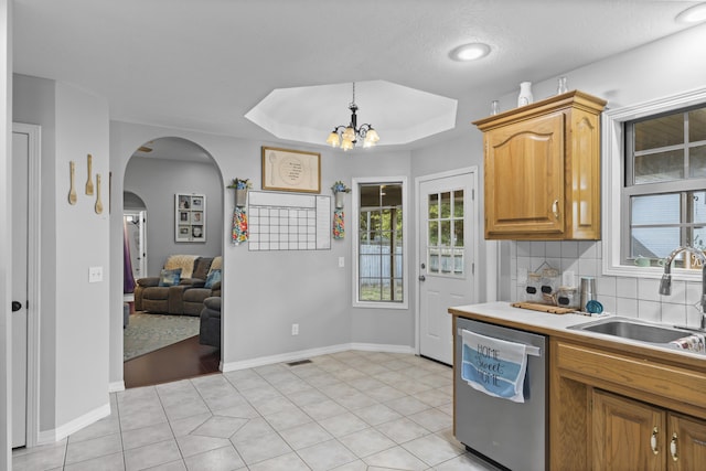 kitchen featuring dishwasher, an inviting chandelier, plenty of natural light, and sink