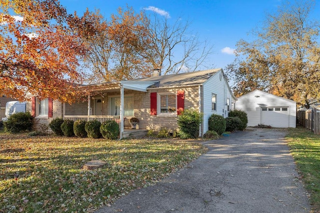 view of front facade featuring covered porch, a garage, an outdoor structure, and a front yard