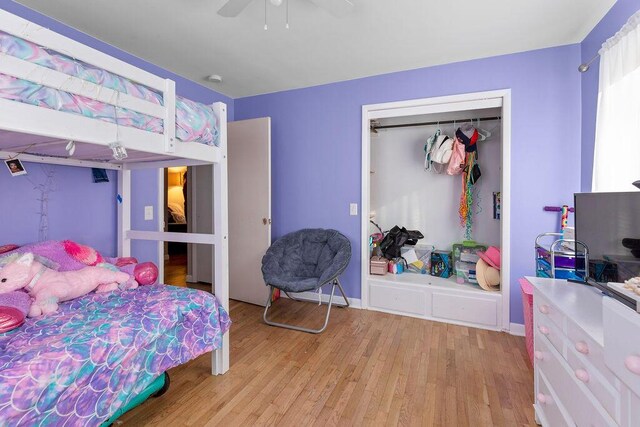 bedroom with a closet, ceiling fan, and light hardwood / wood-style flooring