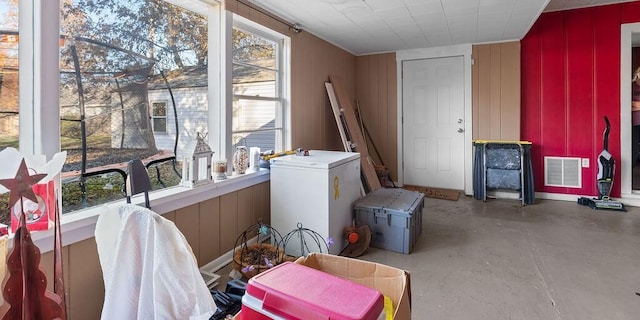 laundry room with wooden walls