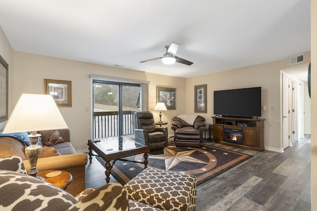 living room with dark hardwood / wood-style floors and ceiling fan