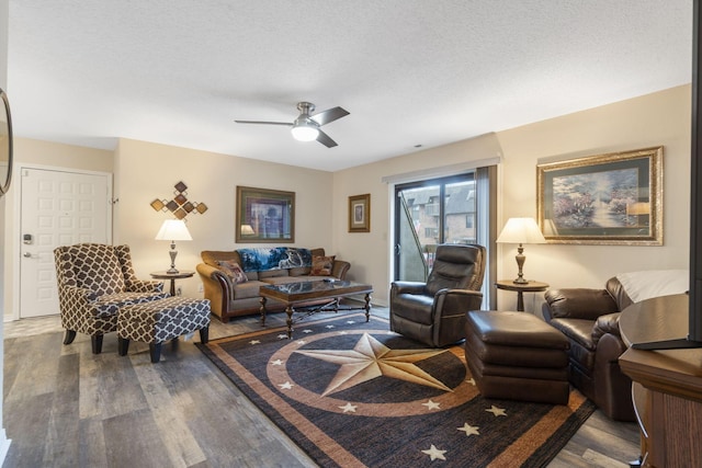 living room with hardwood / wood-style floors, ceiling fan, and a textured ceiling