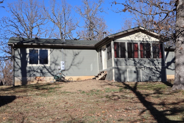 exterior space featuring a sunroom and a yard