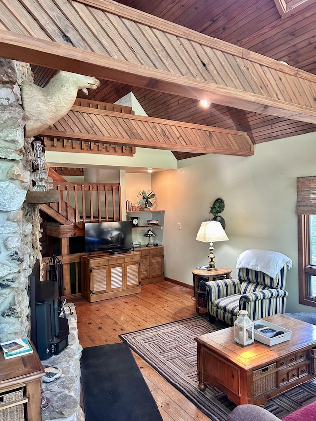 living room with wood ceiling, vaulted ceiling with beams, and light hardwood / wood-style floors