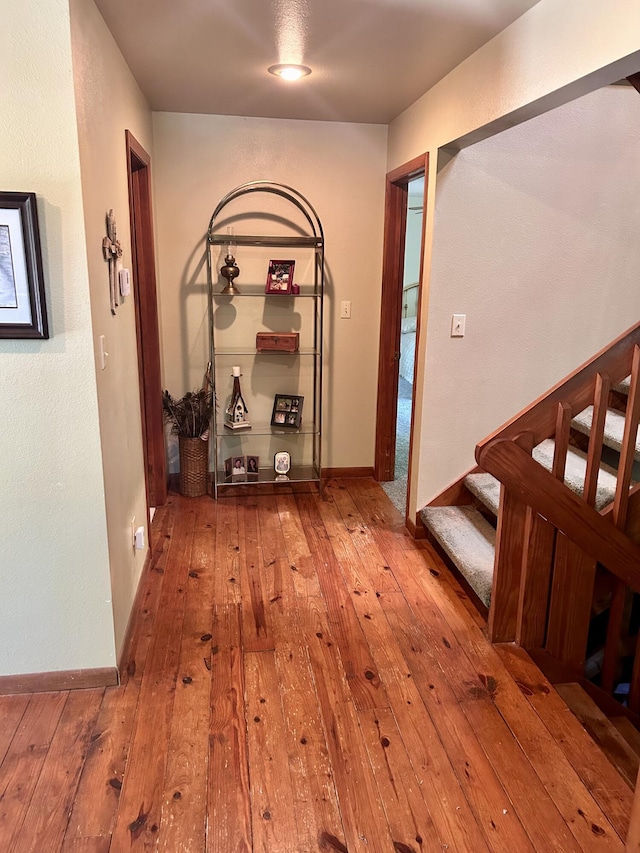 hall with hardwood / wood-style flooring