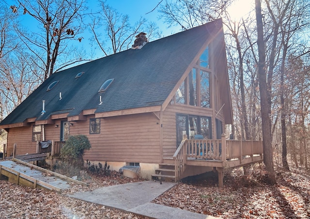 back of property with a wooden deck