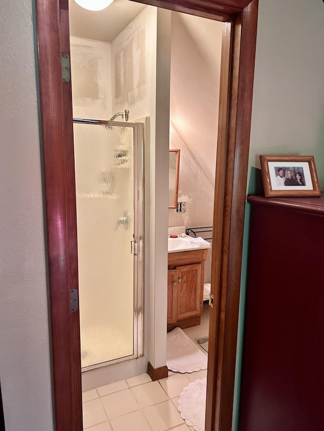 bathroom with tile patterned flooring, vanity, and an enclosed shower