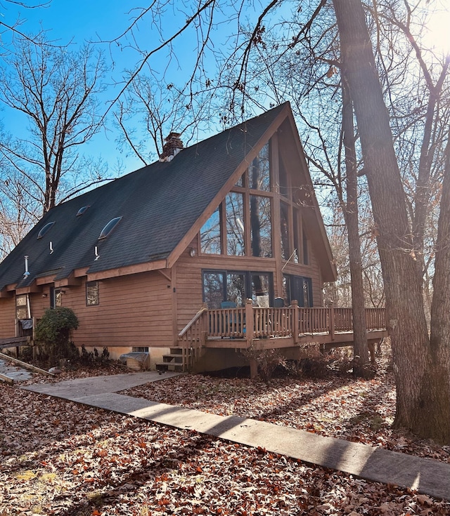 rear view of property with a wooden deck