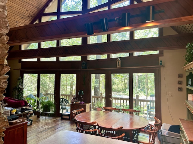 dining area featuring french doors, lofted ceiling with beams, hardwood / wood-style flooring, and wood ceiling