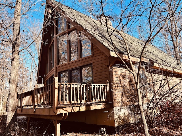 view of home's exterior featuring a wooden deck