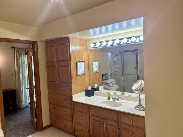 bathroom with vanity, tile patterned floors, and a shower with door