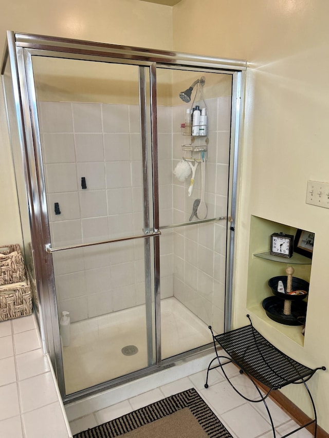 bathroom featuring tile patterned floors and a shower with door