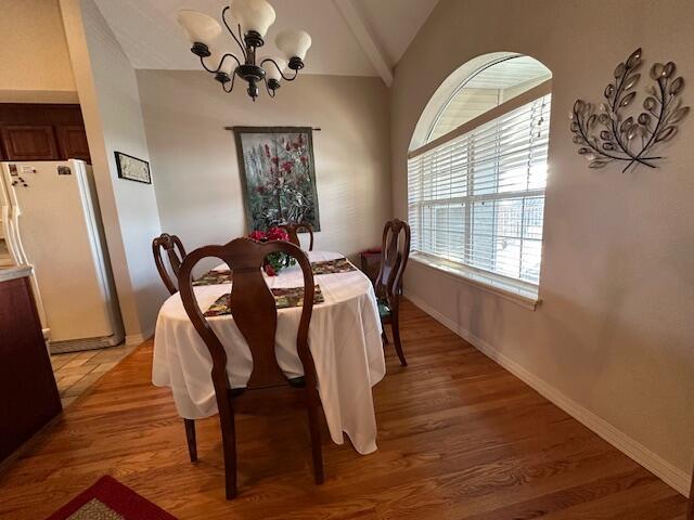 200 Glory Rd Unit C8, Branson, MO 65616 - dining space with lofted ceiling, a chandelier, and light wood-style flooring