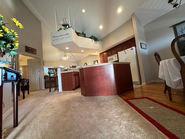 200 Glory Rd Unit C8, Branson, MO 65616 - kitchen featuring white appliances, a ceiling fan, light countertops, light carpet, and a center island