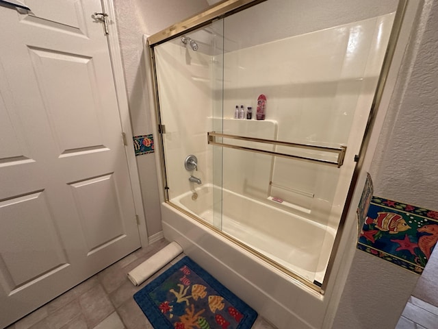 200 Glory Rd Unit C8, Branson, MO 65616 - full bath featuring combined bath / shower with glass door, a textured wall, and tile patterned flooring