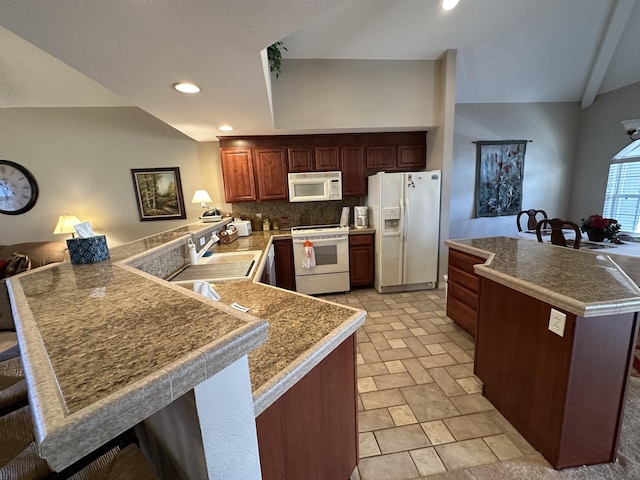 200 Glory Rd Unit C8, Branson, MO 65616 - kitchen featuring white appliances, a peninsula, a breakfast bar area, backsplash, and recessed lighting