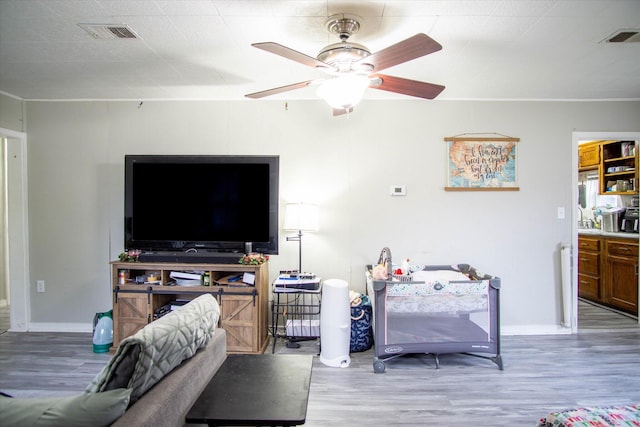 living room featuring hardwood / wood-style flooring and ceiling fan