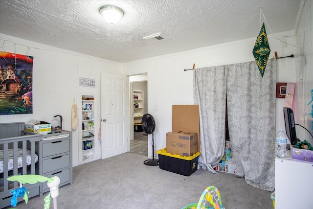 bedroom featuring crown molding, light colored carpet, and a textured ceiling