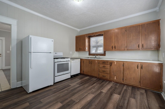 kitchen featuring crown molding, sink, dark hardwood / wood-style floors, and white appliances