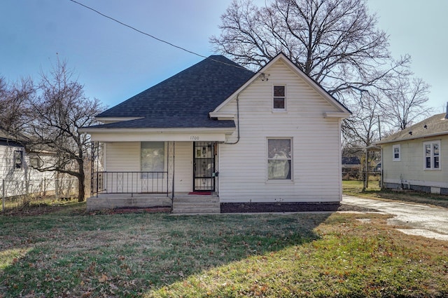 bungalow with covered porch and a front yard