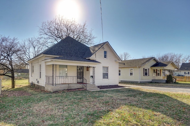 bungalow with a front lawn and a porch