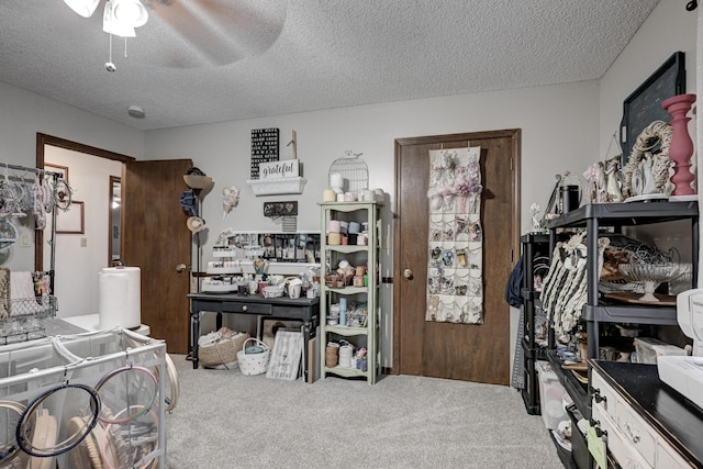 bedroom featuring carpet flooring, ceiling fan, and a textured ceiling