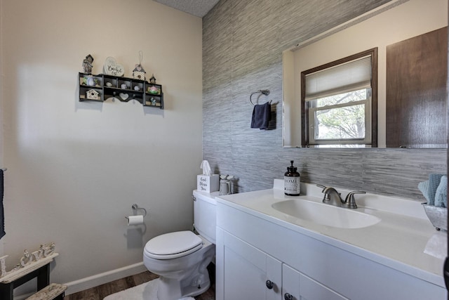 bathroom with hardwood / wood-style flooring, vanity, toilet, and tile walls