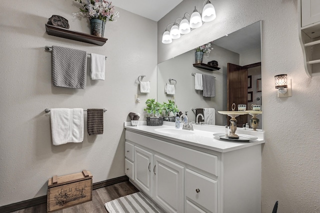 bathroom with vanity and wood-type flooring