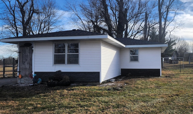 view of side of home with a lawn