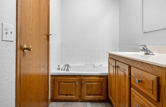 bathroom with tile patterned flooring, vanity, and a bathtub