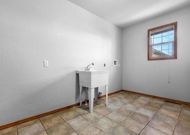 laundry area with light tile patterned floors and washer hookup